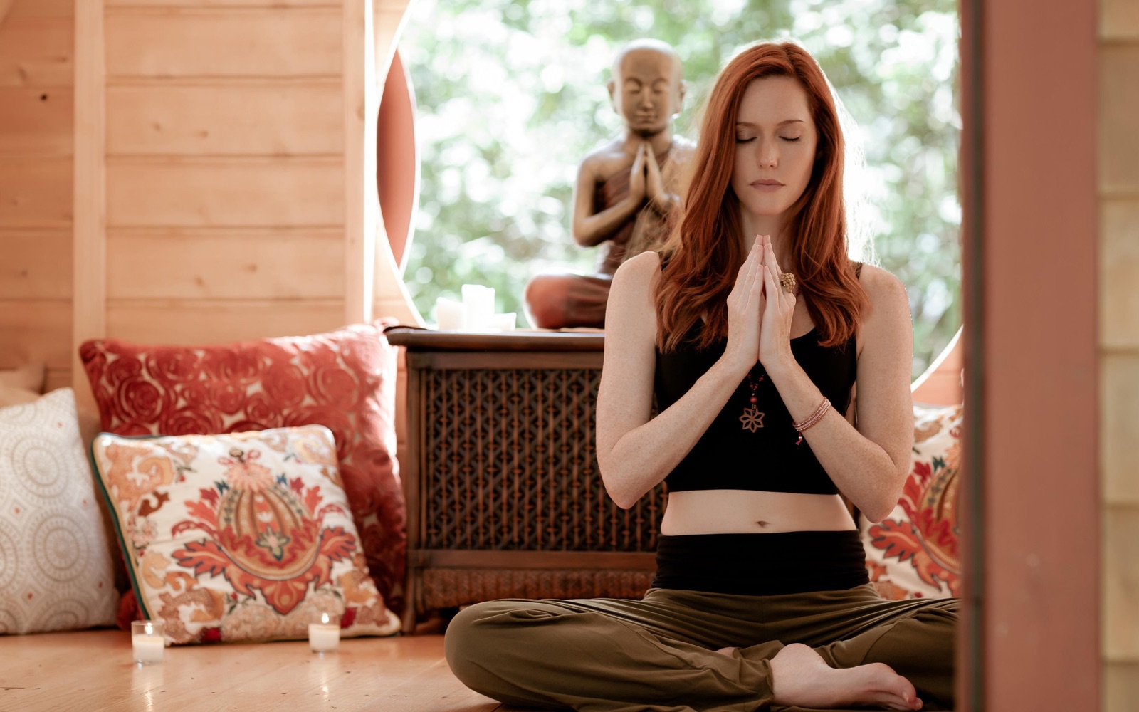 A guest meditating at home, continuing the daily practice between visits